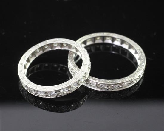 Two platinum and diamond full eternity rings, size R.